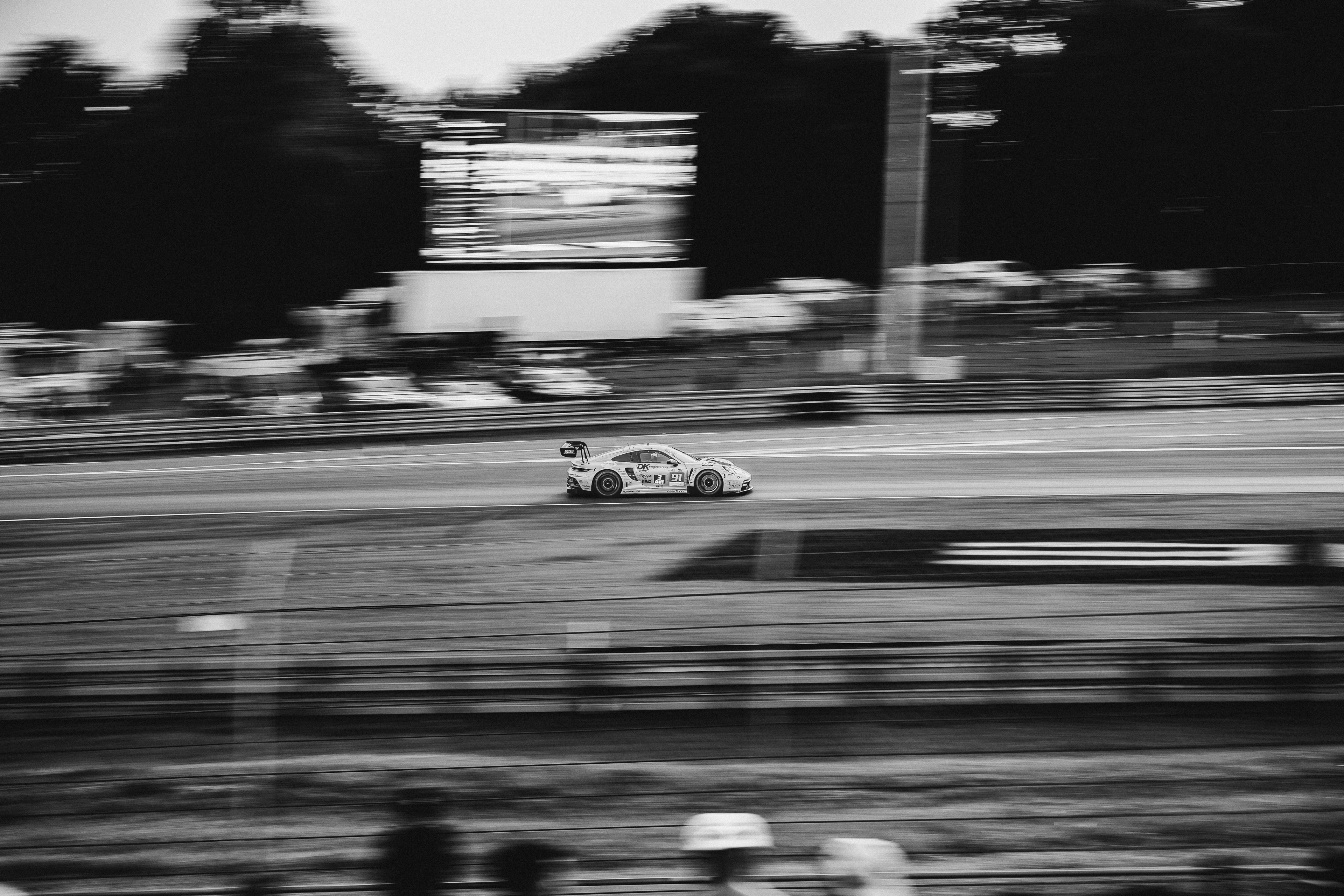 Porsche 911 GT3 R number 91 at speed in a panning shot at Le Mans